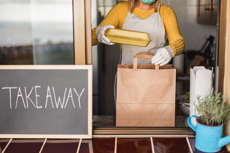 Restaurant employee loading takeout order