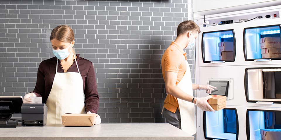 Employees loading OrderHQ™ Smart Food Locker