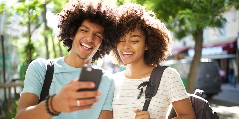 Students smiling with phone