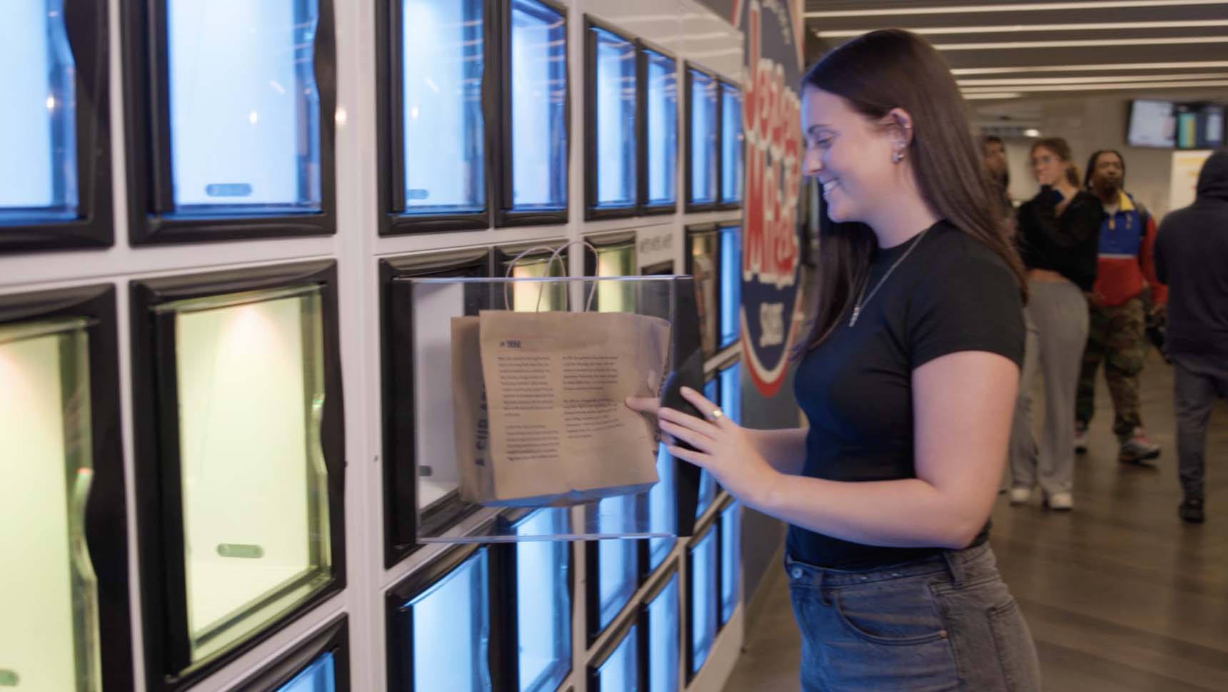 female student using a food locker at rider university.