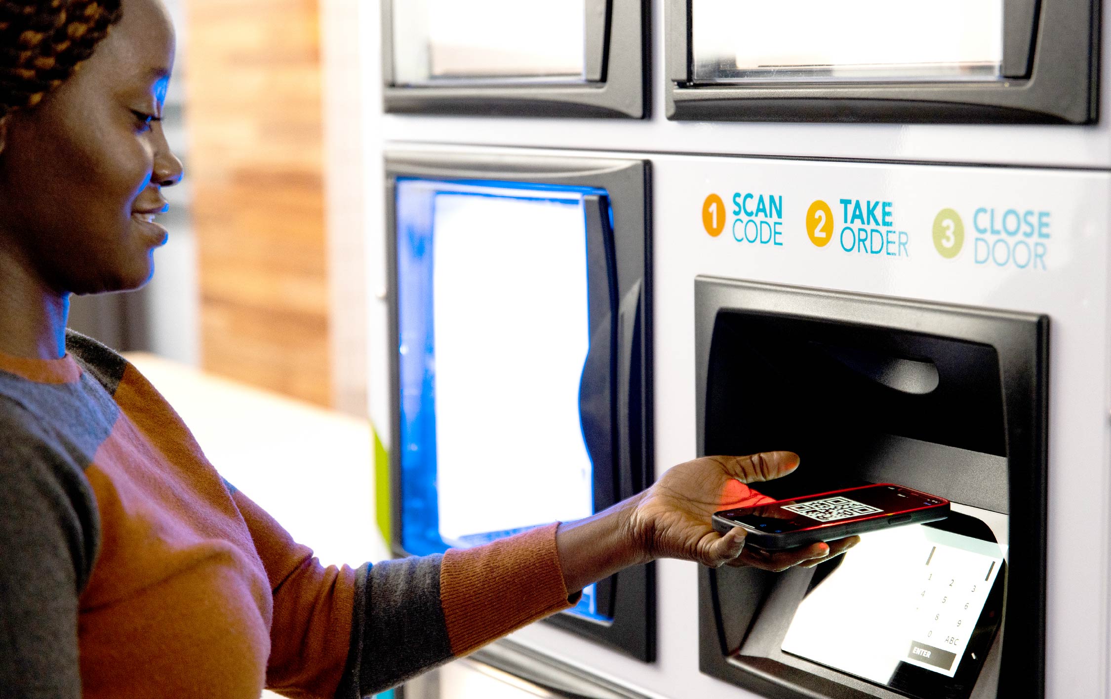 woman scanning a qr code at an apex locker